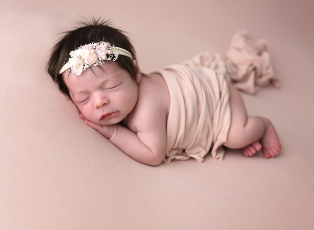 Side lying pose on my peach backdrop and wrap, posing bag poses, in my cozy studio located in Wallingford, CT 