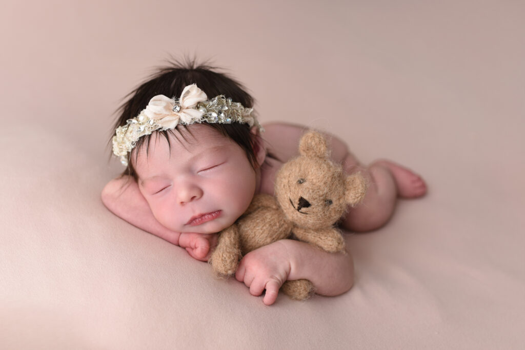 My second most requested pose, chin on hands , done with soft peach backdrop and sweet lovie teddy bear, again done at my cozy studio located in Wallingford 
