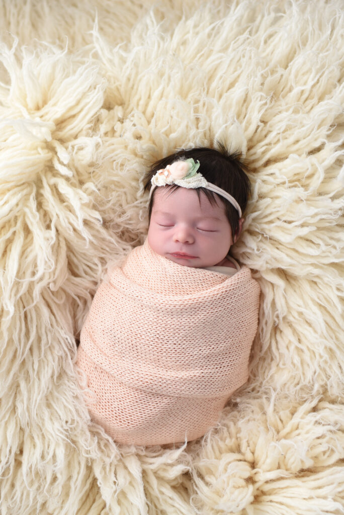peach and cream wrap & and headband on a cream flokati  makes a beautiful combination .  Another favorites for parents. 