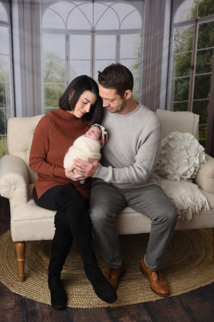 Mom & Dad with their sweet baby girl, all wrapped up nice and snuggly, during my lifestyle portion of this newborn session  