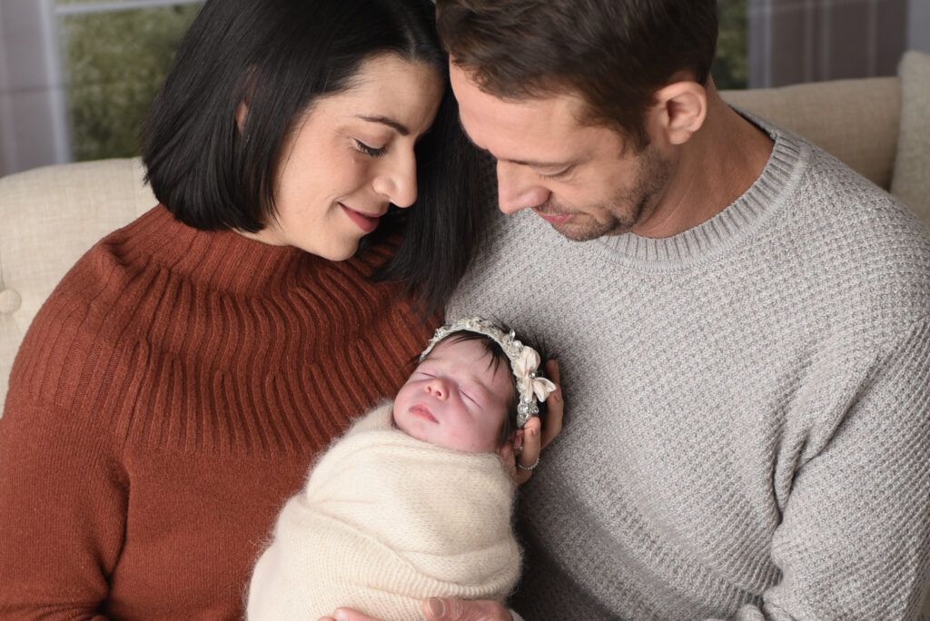 Mom & Dad with their sweet baby girl, all wrapped up nice and snuggly, during my lifestyle portion of this newborn session  