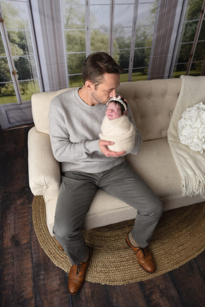 Dad with his sweet baby girl, all wrapped up nice and snuggly 