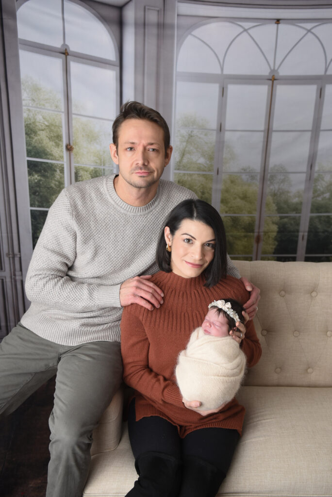 Mom & Dad with their sweet baby girl, all wrapped up nice and snuggly, during my lifestyle portion of this newborn session  