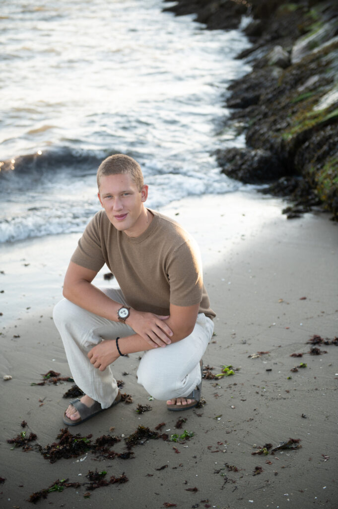 Senior photo walking along the shoreline at Meigs Point, Hammonasset Beach State Park, Madison CT”