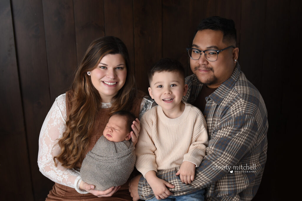 Family of four with newborn baby boy and toddler during Wallingford CT studio photography session