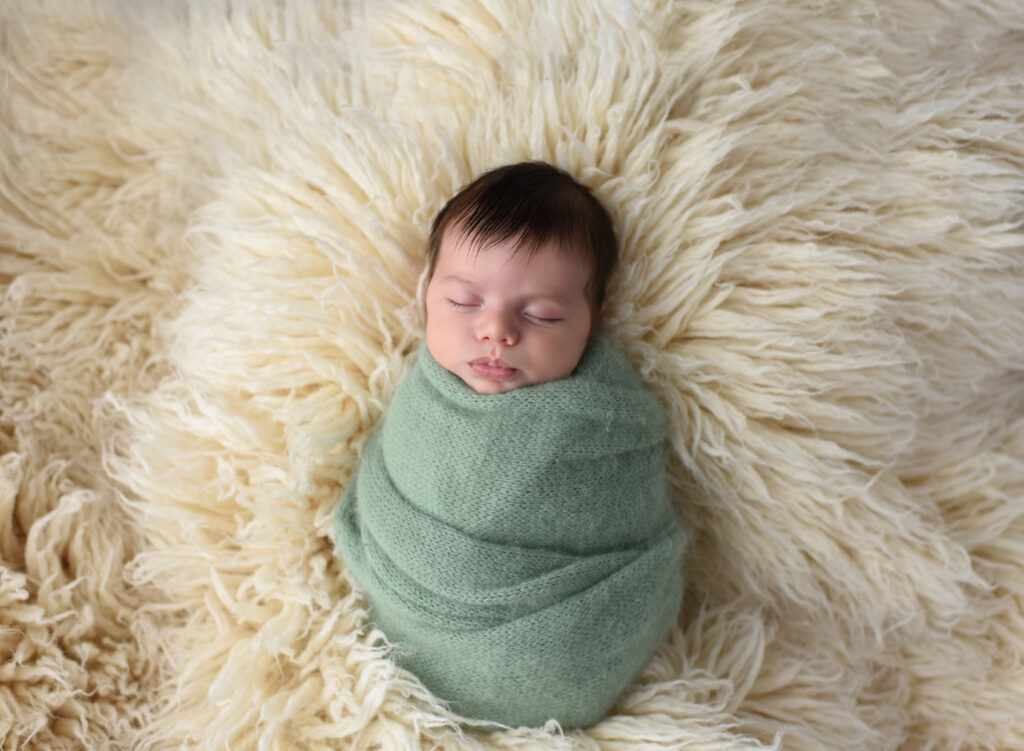 Baby all snuggled up in a wrap during newborn session at Christy Mitchell Photography in Wallingford, CT 