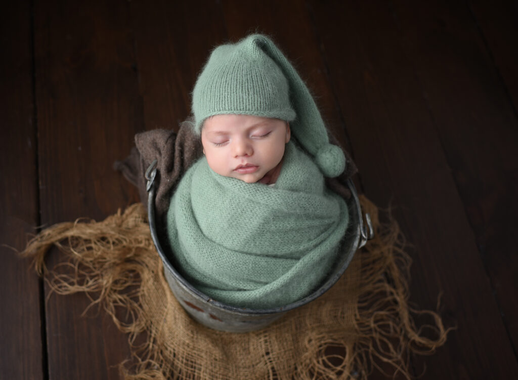 Soft green angora wrap with baby in bucket 
